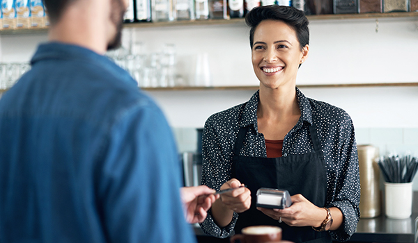 Business woman accepting credit card transaction.