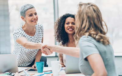 Three professional women meeting.
