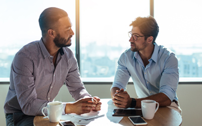 Two men meeting over coffee