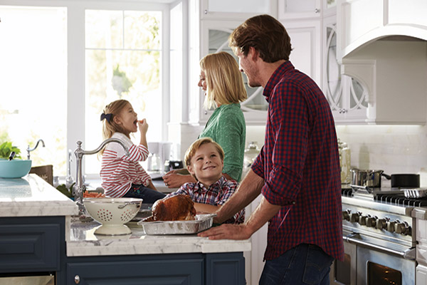 Family in kitchen.