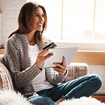 Woman paying online with debit card